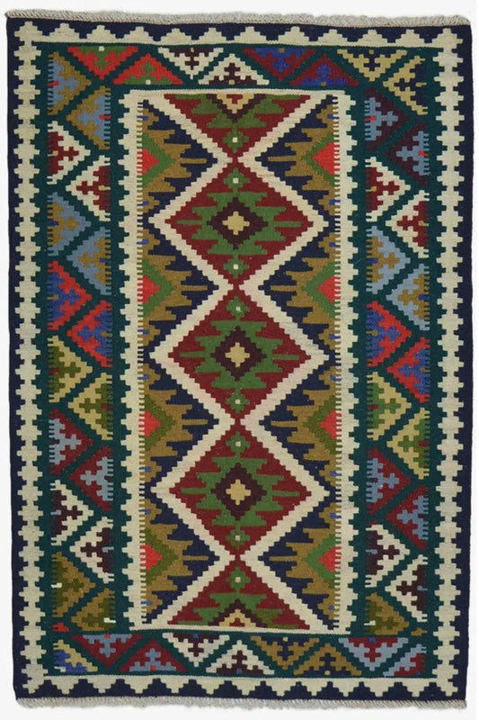 Straight-on view of a multicolored kilim rug with a diamond pattern and framed border border