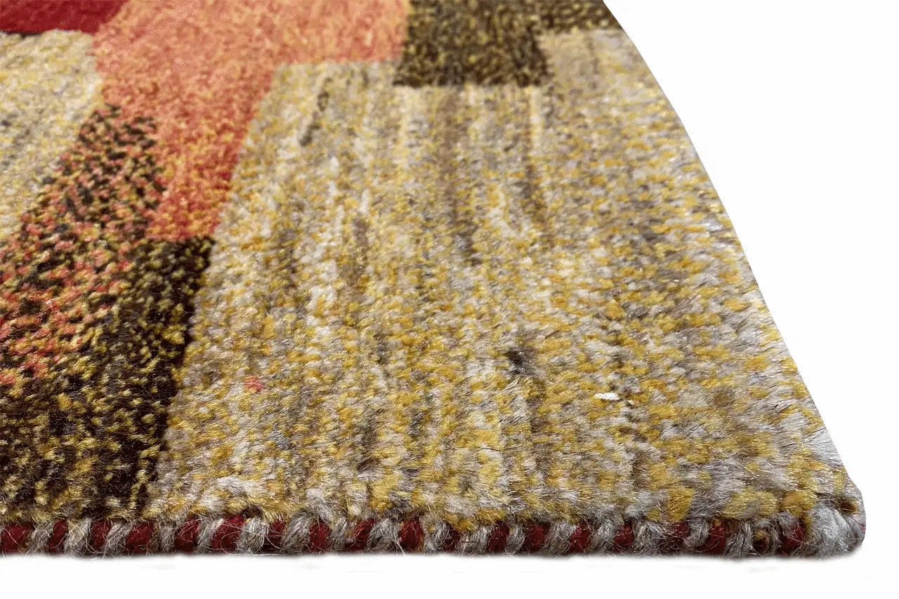 Close-up of a Gabbeh rug: multicolored virgin wool with fringes along the edge