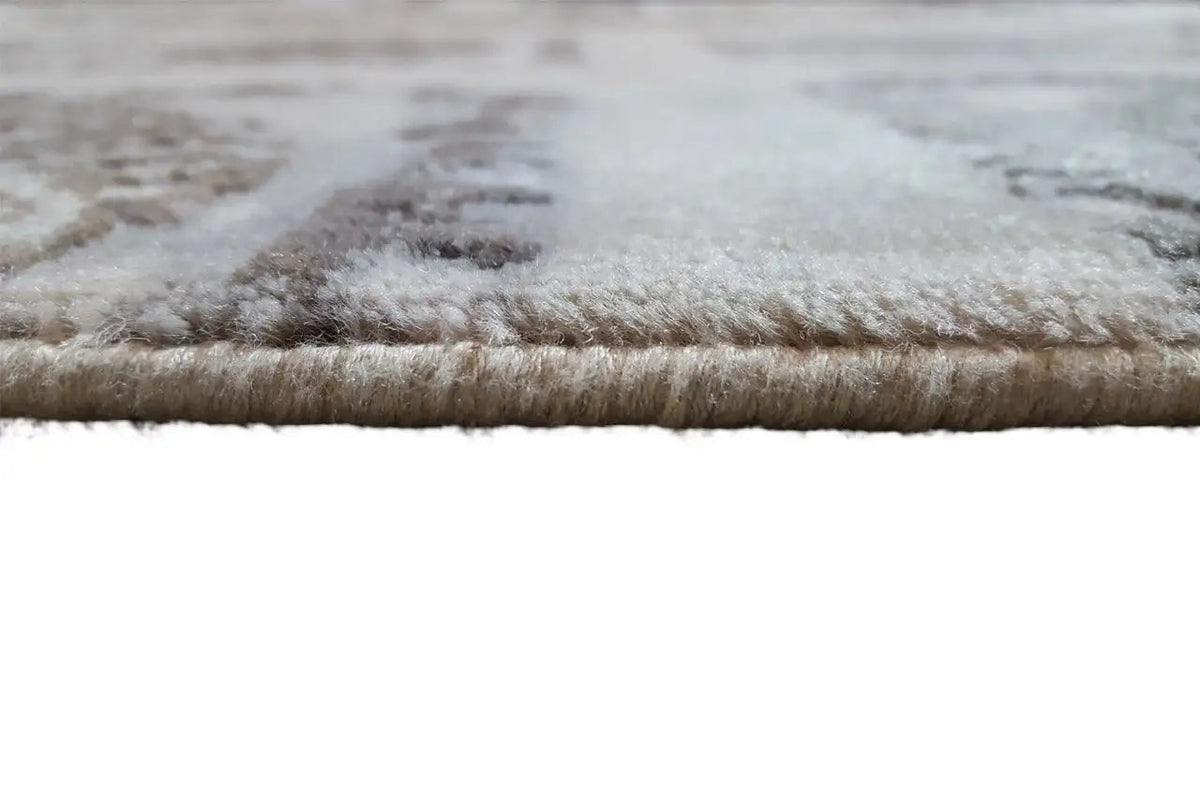 Rug edge and pile in the close-up: beige with dark patterned areas