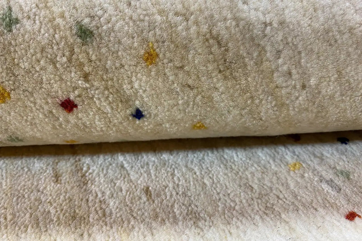 Gabbeh rug, detail of the pile with multicolored dots and a soft looped texture