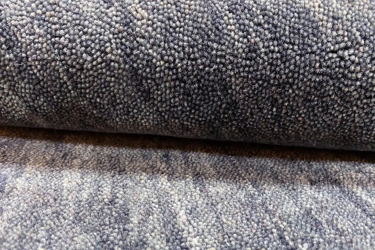 Gabbeh rug with a dense pile, mottled blue-gray texture, close-up view