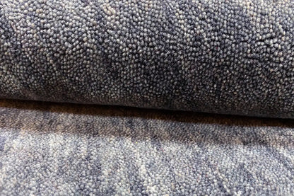 Gabbeh rug with a dense pile, mottled blue-gray texture, close-up view