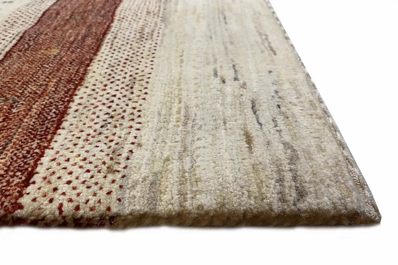 Close-up of Gabbeh rug: burgundy border area and cream-colored pile