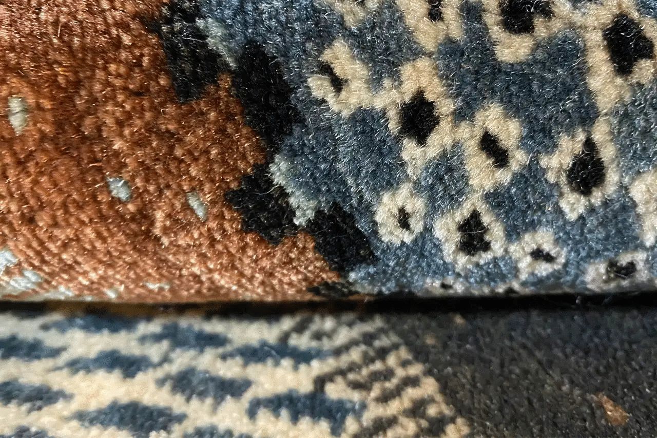 Gabbeh rug detail: pile with ornamental dots in brown, blue, and cream