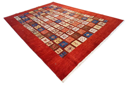 Rug with red pile and a central patchwork pattern in blue, beige, and red