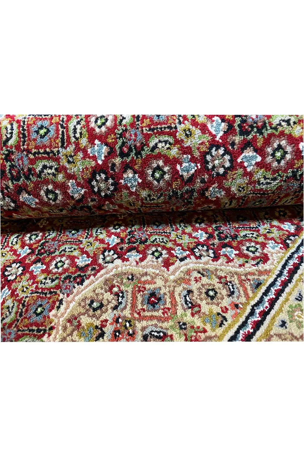 Indo Tabriz carpet close-up with a dense, colorful floral pattern and ornate border