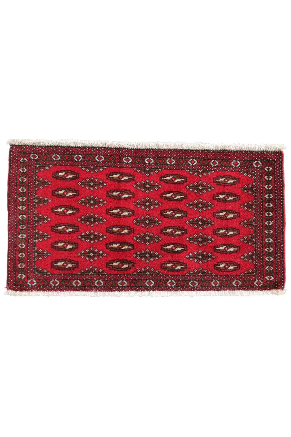 Rectangular red Turkmen carpet with a dark border and short white fringes