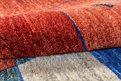 Gabbeh rug Lori close-up of the red wool pile with blue-outlined color fields