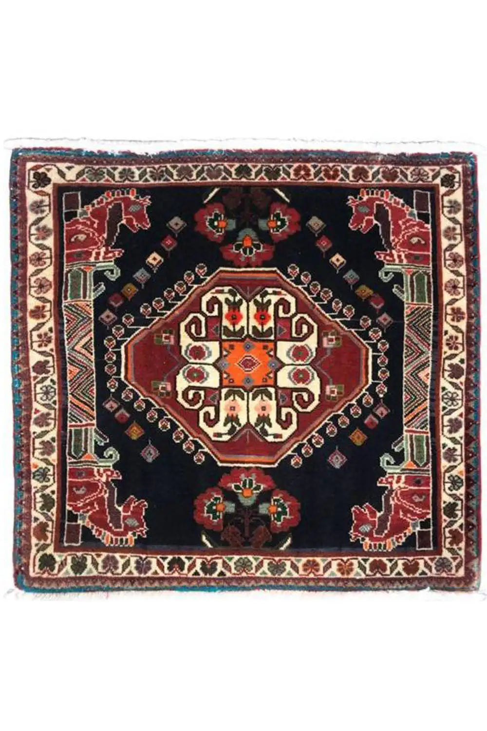 Square Oriental rug with a dark blue background, red central medallion, and fringes