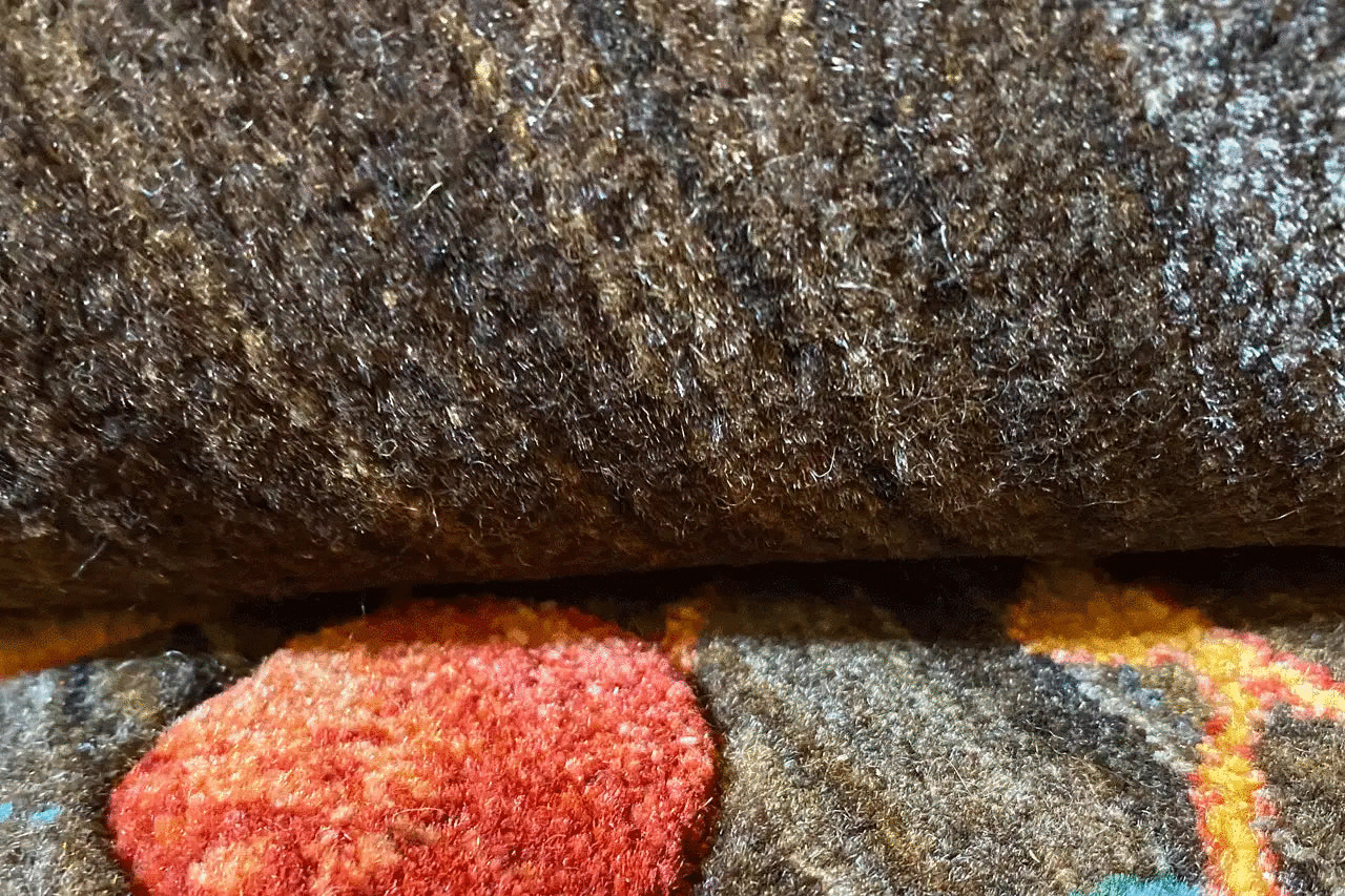Gabbeh rug Lori: wool fiber detail with brown pile and colorful sections
