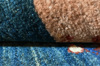 Carpet detail with blue pile, brown and beige stripe, and colorful dots