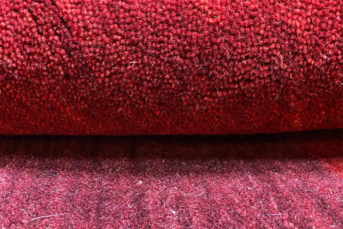 Gabbeh rug with red pile and dark areas, 242×172 cm