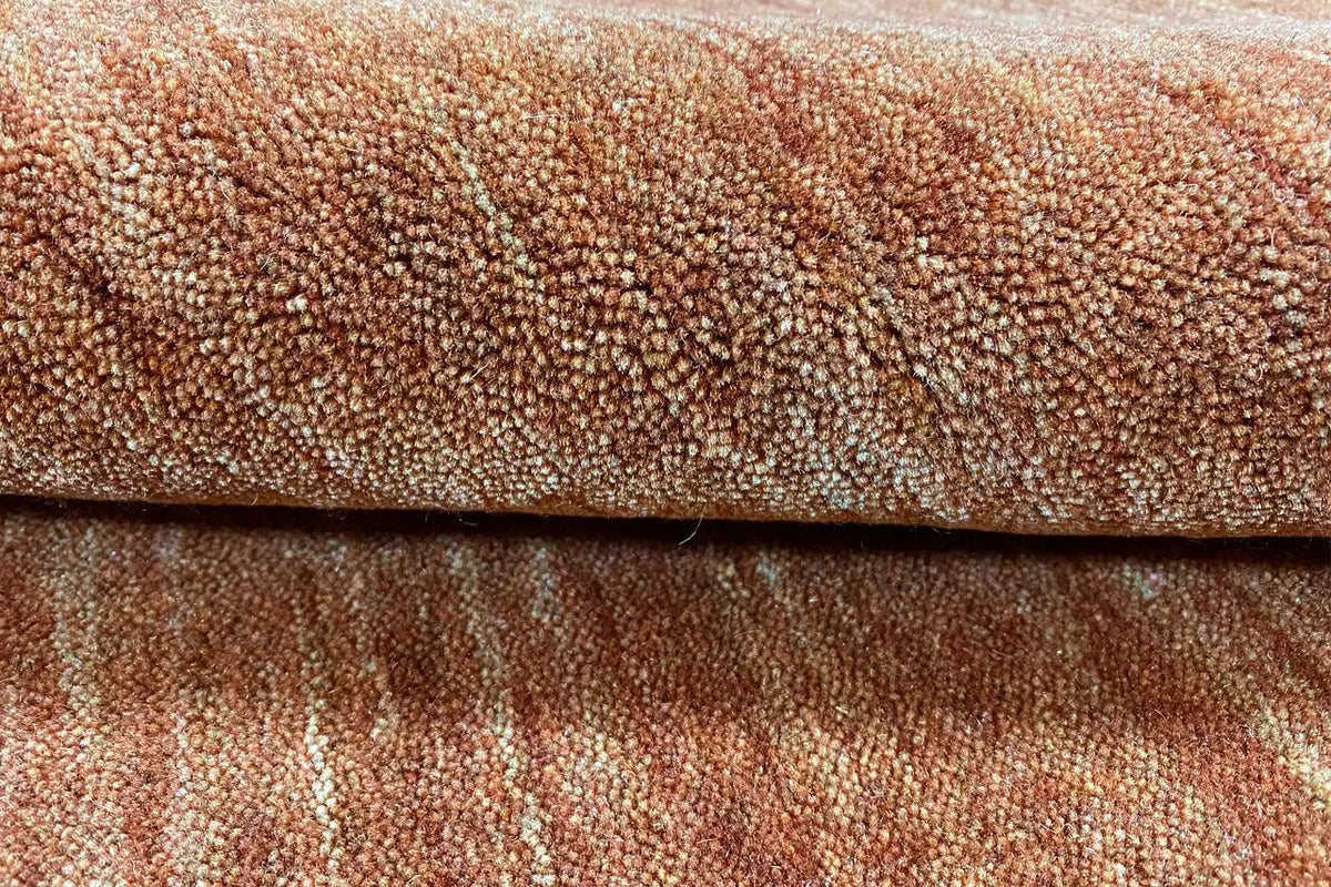 Close-up of the web structure of a brown Gabbeh rug with fine pattern lines