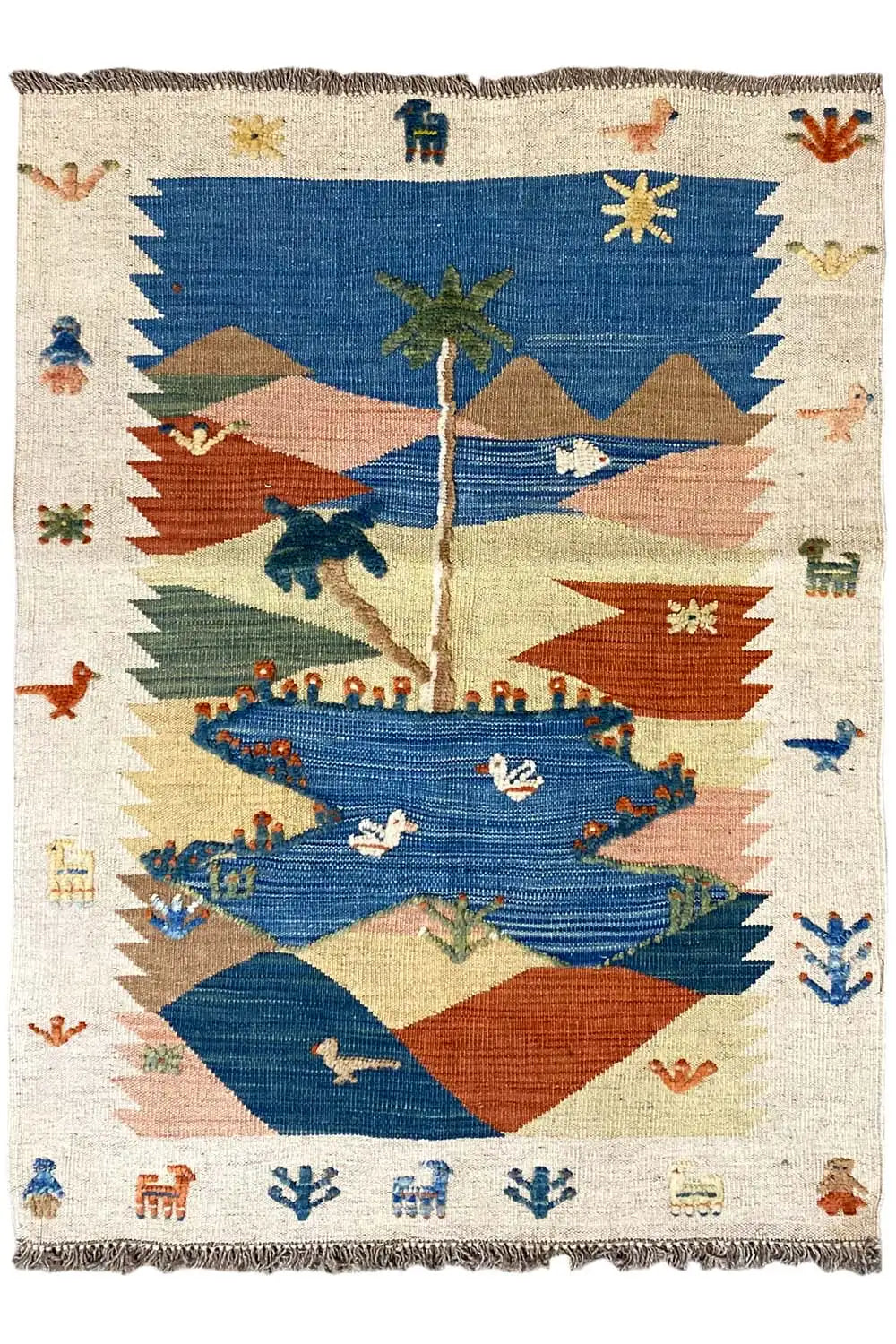 Kilim rug, cream-colored with a blue central medallion, red mountains, stars, and ornamental figures