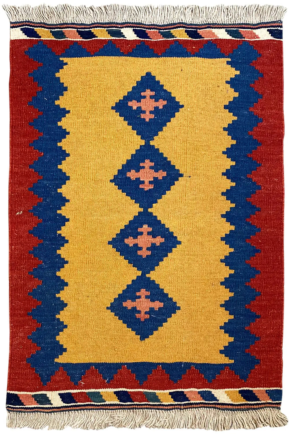 Kilim rug with a red border, yellow field, and blue diamonds; embroidered fringes