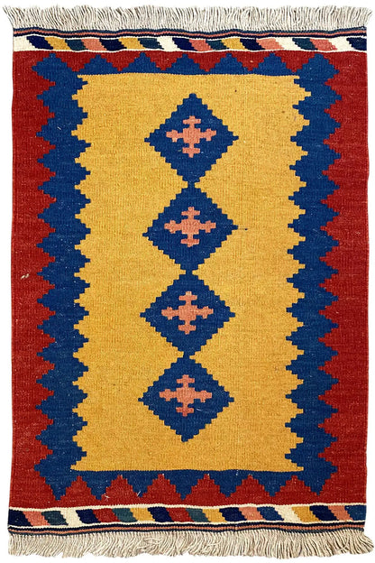 Kilim rug with a red border, yellow field, and blue diamonds; embroidered fringes