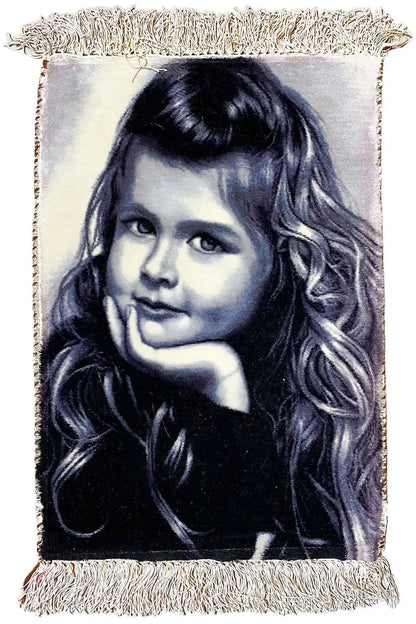 Frontal tapestry with a portrait of a girl, rectangular, light beige fringe.