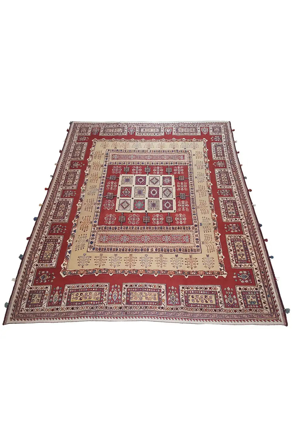 Rug, laid at an angle: red patterned area with a beige background and blue border
