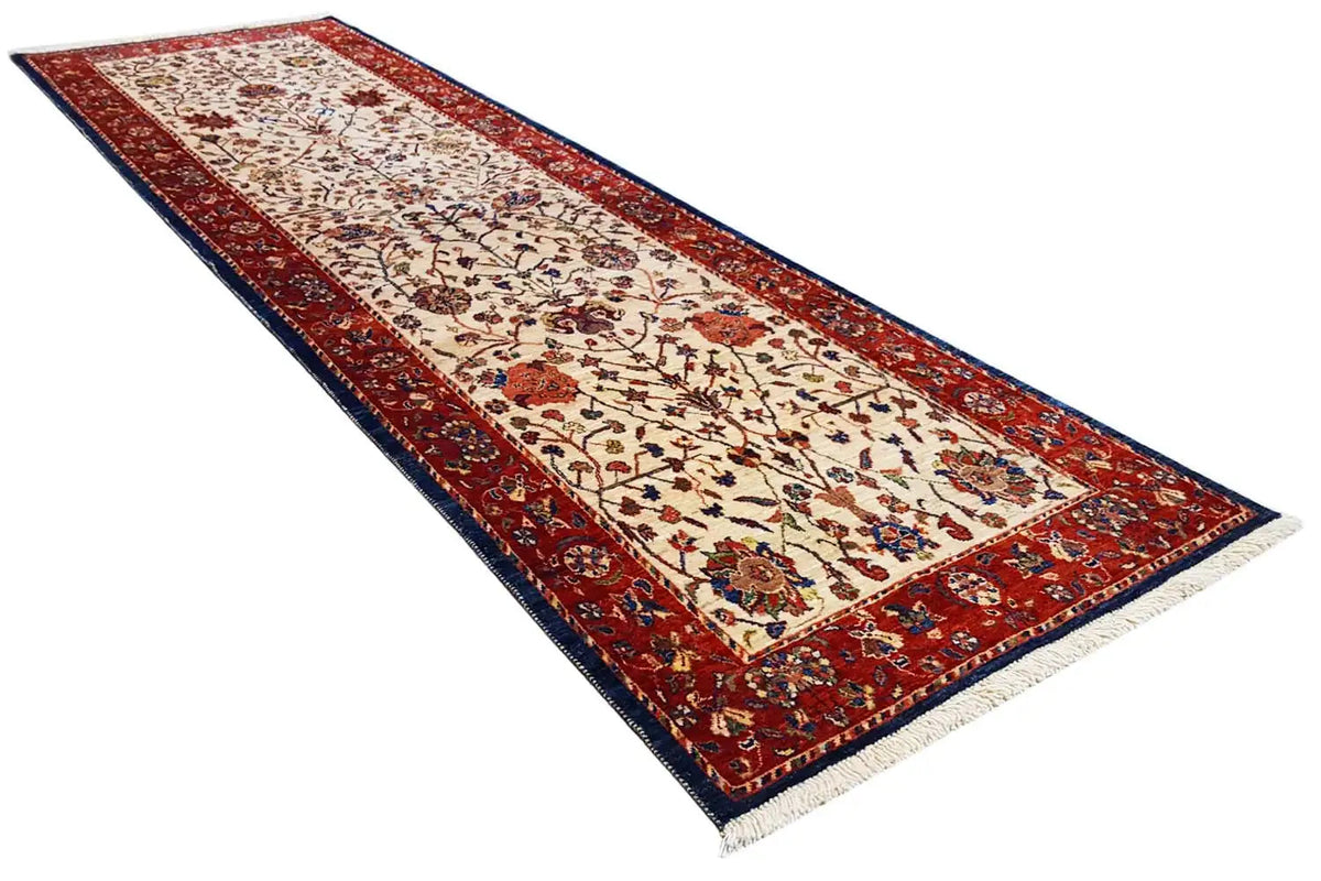 Oriental runner rug with a red border, cream-colored field, and floral pattern accents