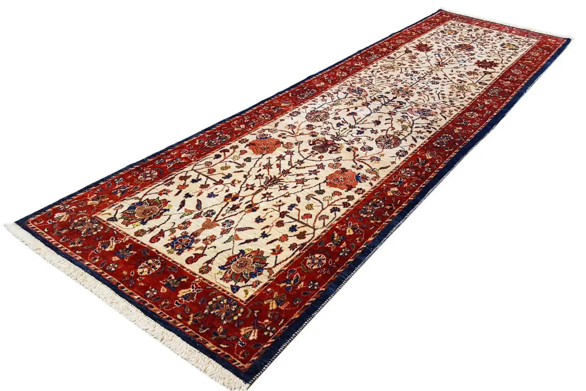 Oriental rug runner with a red border, cream-colored central field, and blue-red ornaments