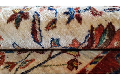 Carpet detail: cream-colored pile with multicolored ornamental lines and floral motifs