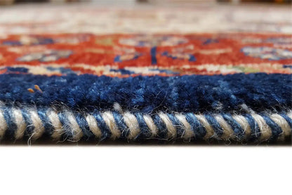 Rug edge with woven border and short fringed finish in blue and red