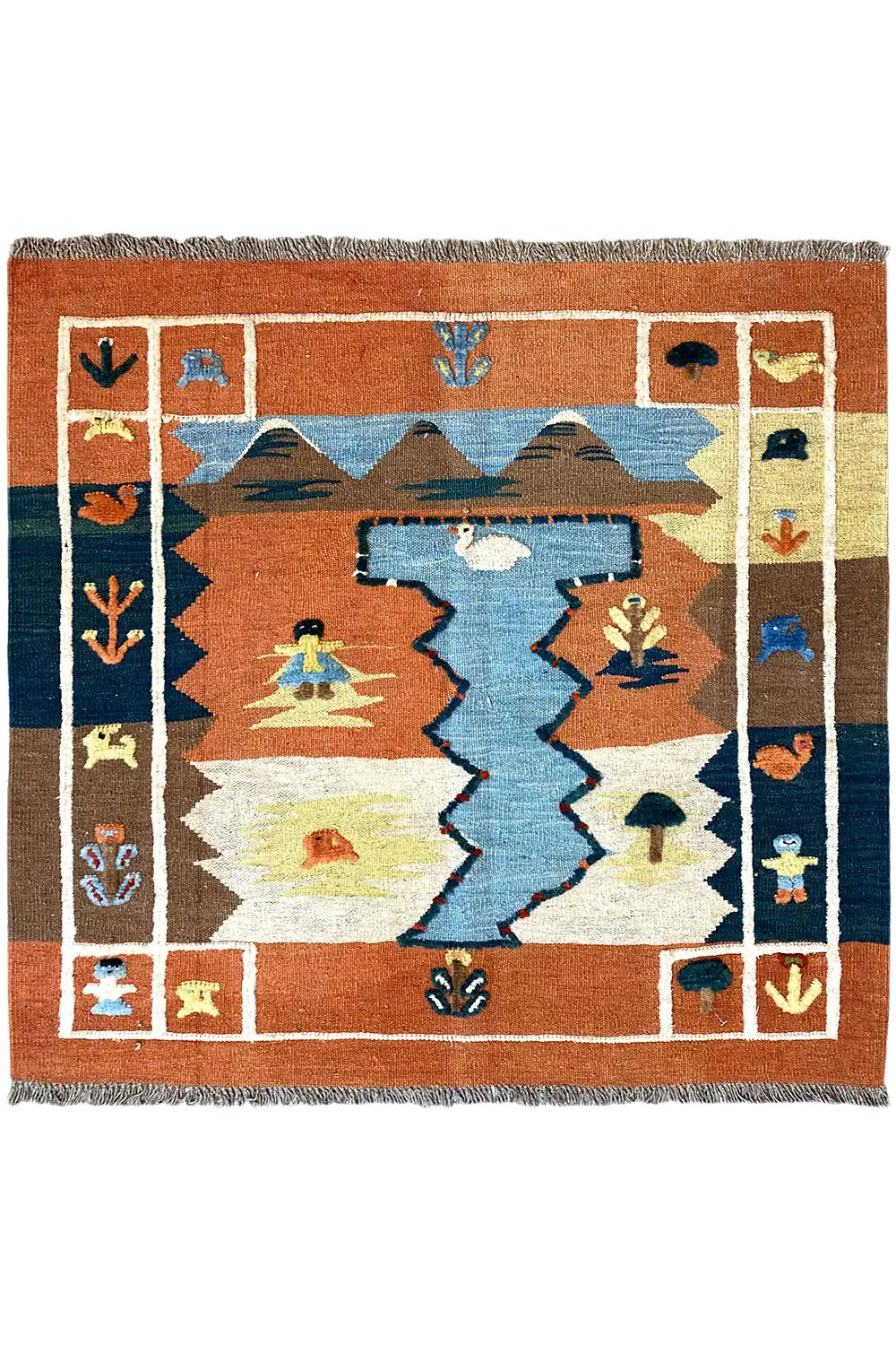 Kilim rug with a geometric pattern in terracotta, blue and cream, with fringes