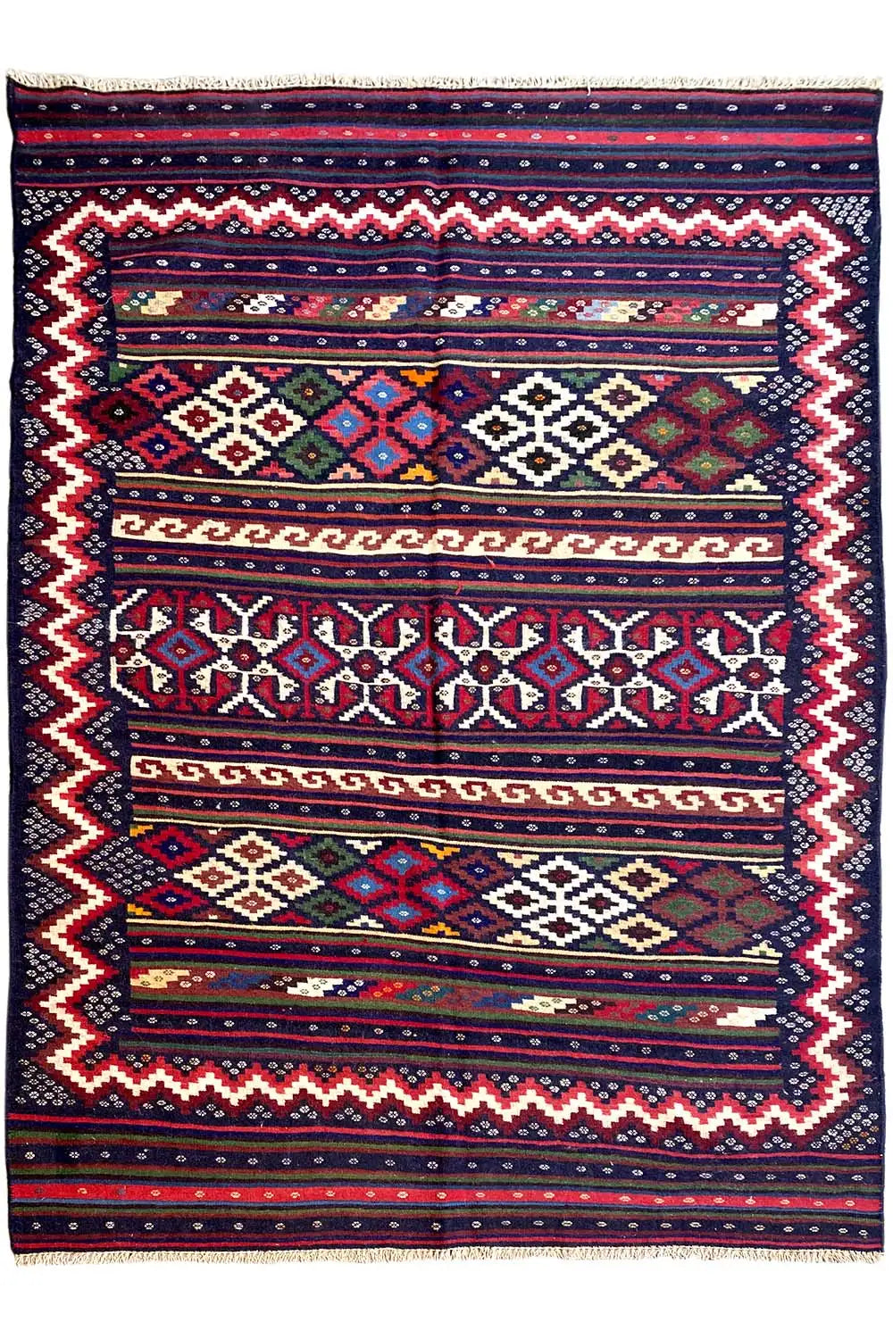 Kilim rug front view: border pattern, diamonds and zigzags, dark blue with colorful accents