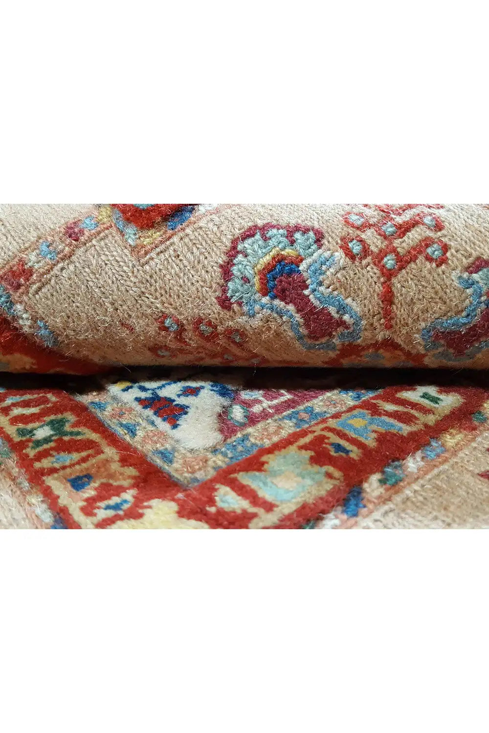 Rug with a woven texture and colorful pattern in blue, red, and beige
