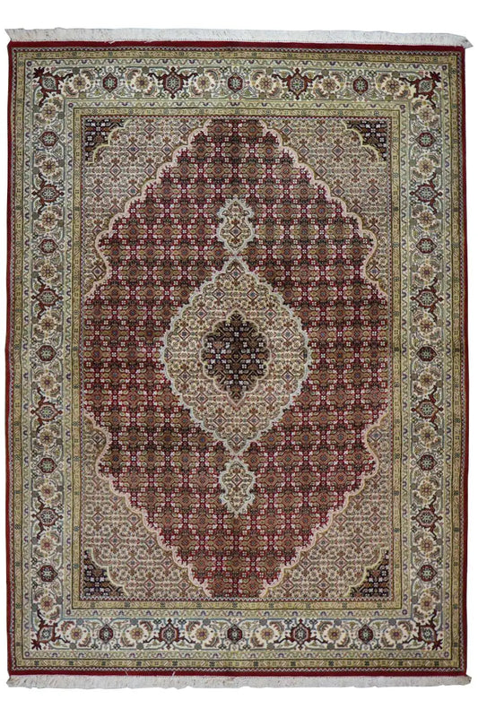 Oriental rug with a brown-and-white medallion pattern and dark border edging