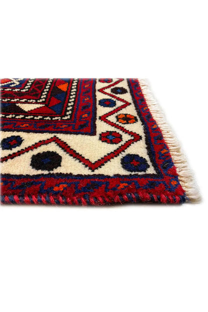 Carpet edge with fringed trim, white background, and a blue-and-red checkered ornament