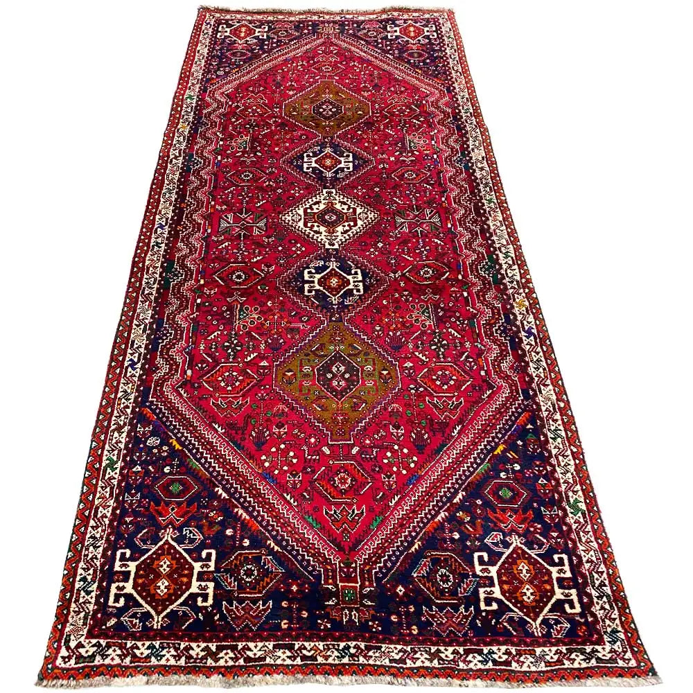 Red-and-blue runner with a central medallion and an even patterned border
