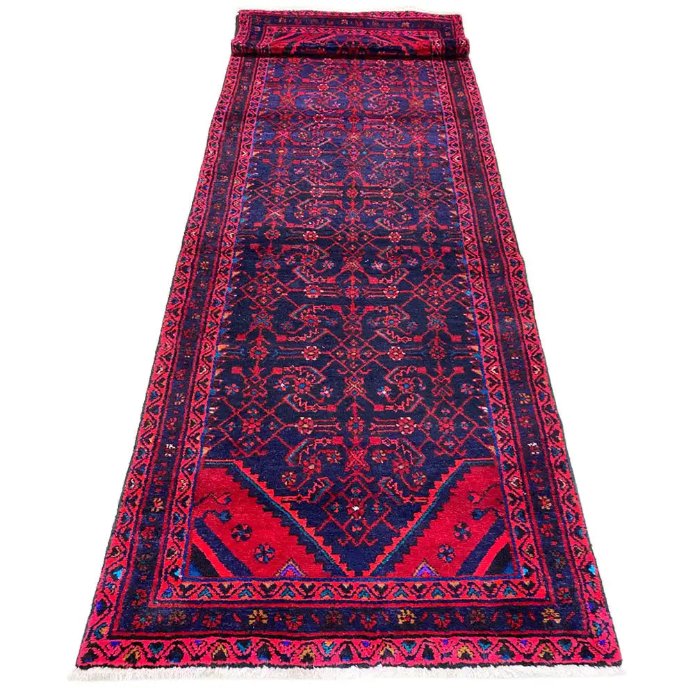 Hamadan runner from above: burgundy central field with dark blue borders and fringes