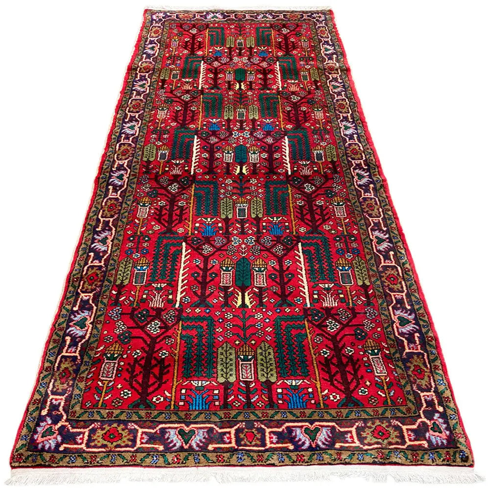 Oriental runner rug with a red detailed pattern, turquoise/green accents, and a wide border