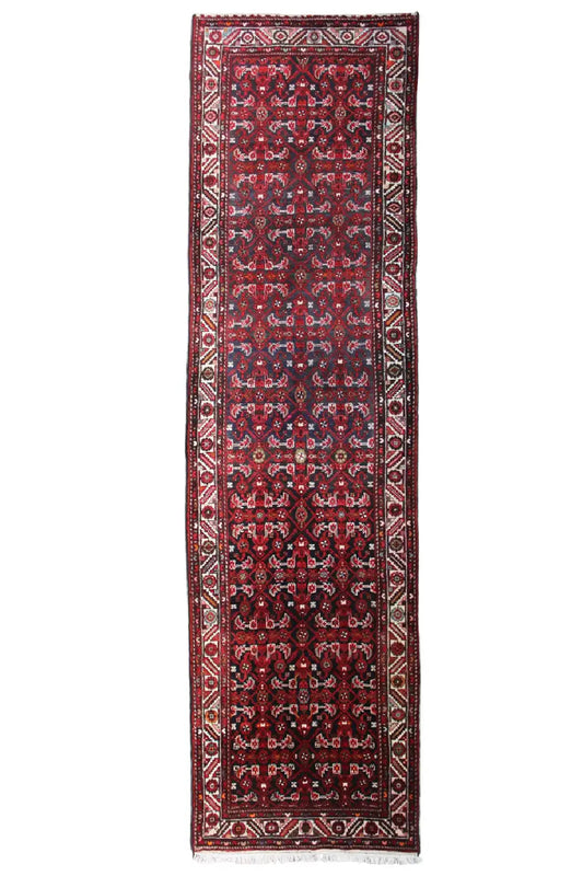 Red rectangular table runner with a blue base color and ornamental central motif