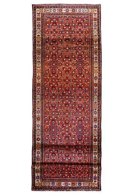 Hamadan runner in portrait orientation: burgundy background with a wide central border and ornamental panels