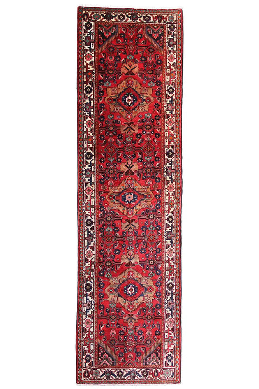 Red rug in a classic Oriental design with dark borders and symmetrical medallions