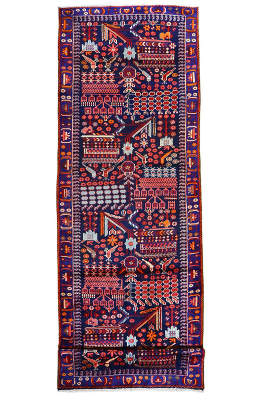Top view of a runner rug with a colorful oriental pattern in red, blue, and beige