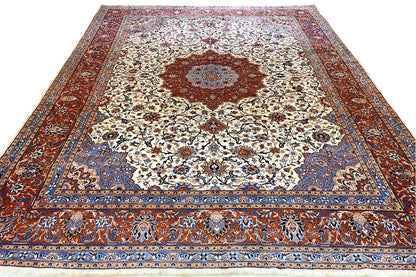 Tabriz oriental rug viewed from above: cream patterned field with a red center and blue border
