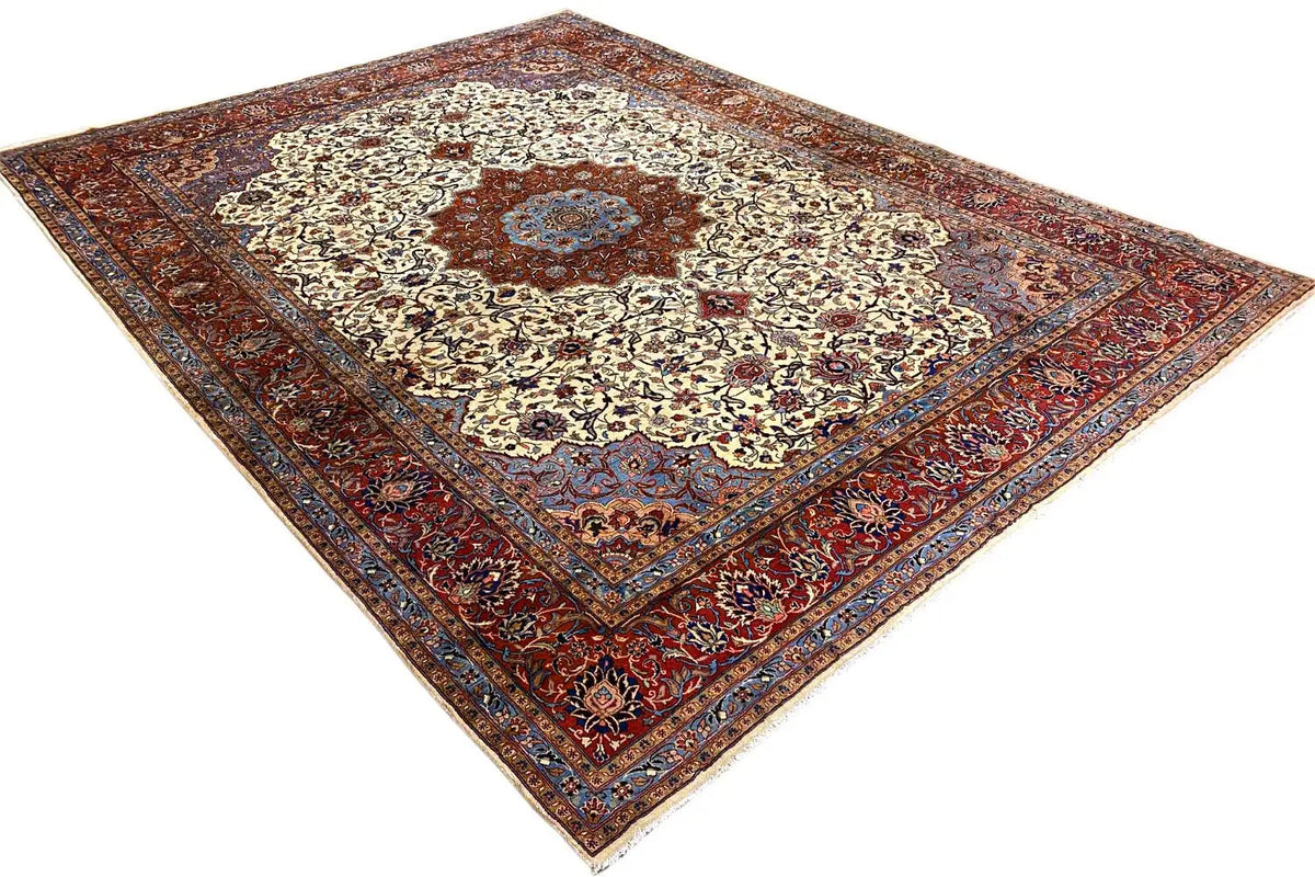 Tabriz Oriental rug, angled view of a cream-colored medallion and red, blue border