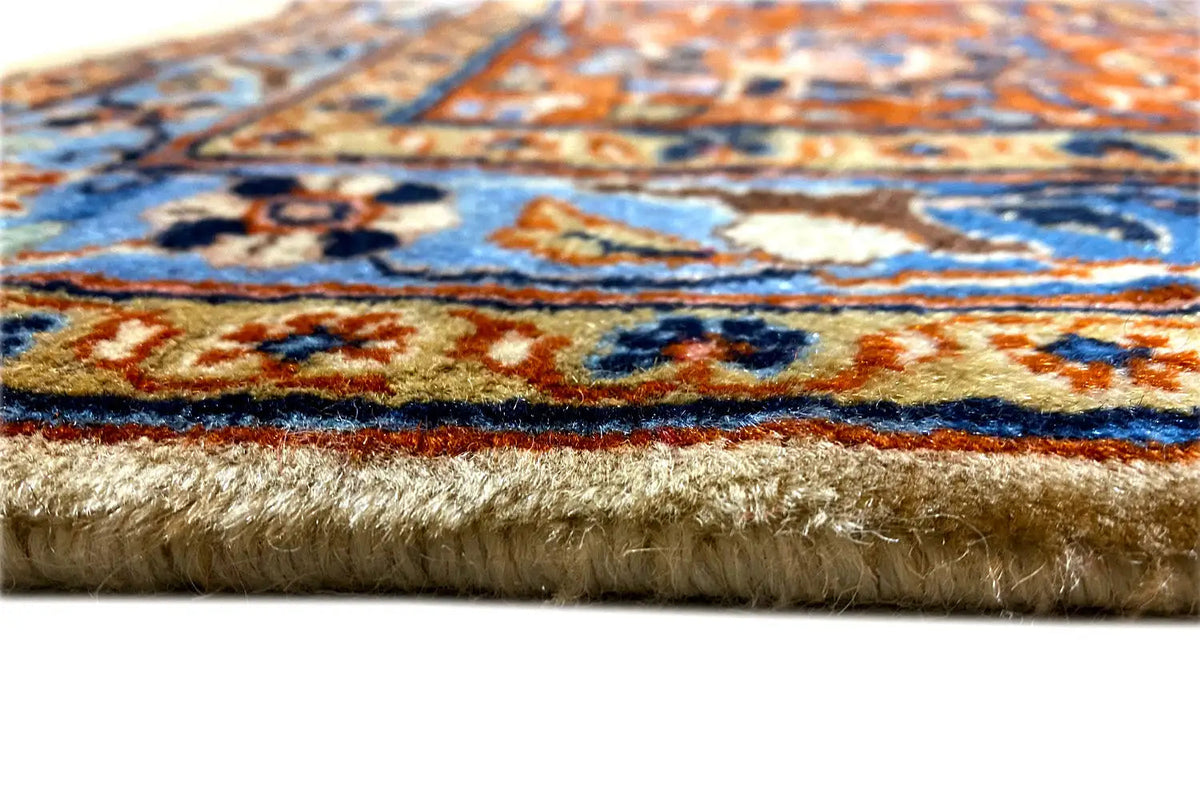 Side view: Tabriz oriental rug with a short fringe border and patterned pile