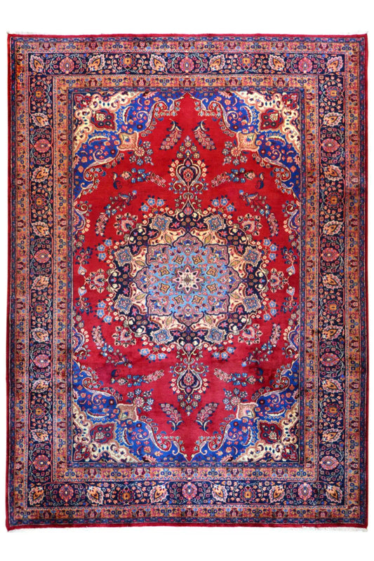 Khorasan rug with a red central medallion, blue border, and intricate ornaments
