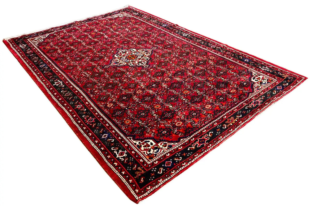 Red carpet with ornamental motifs, dark blue border, and corner medallions