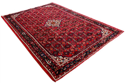 Red carpet with ornamental motifs, dark blue border, and corner medallions