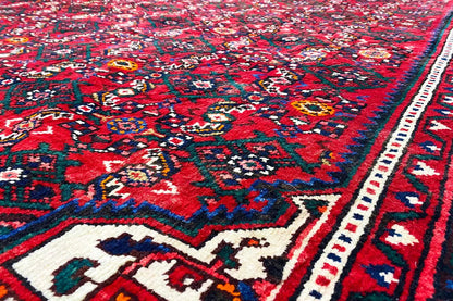 Detailed view: colorful floral patterns on a red background with a blue-and-white border