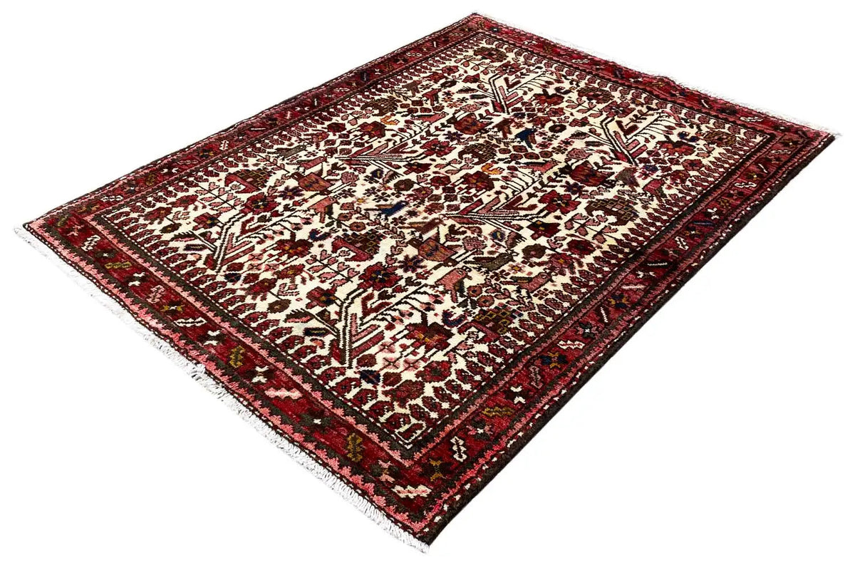 Oriental rug, diagonal view with an ornamental pattern and red border