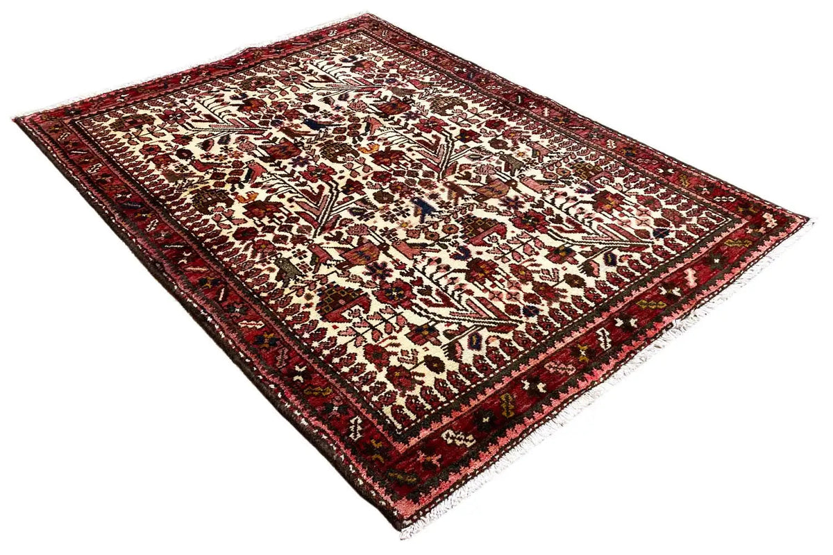 Oriental rug, another perspective with a dense ornamental pattern in red and cream