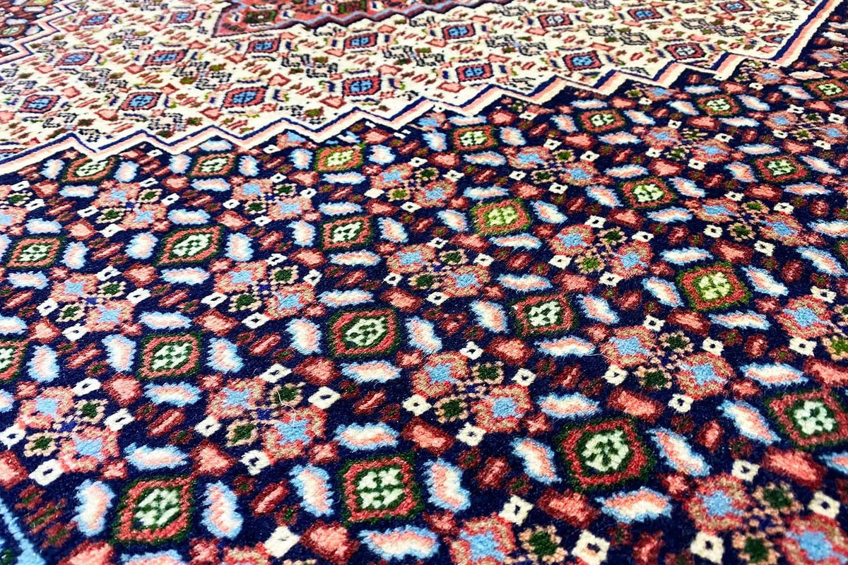 Close-up of the rug pattern: colorful geometric ornaments on a dark background