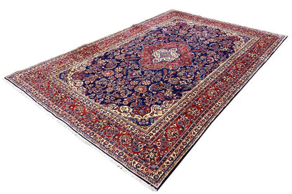 Diagonal rug: blue medallion, red-and-white border, and delicate decorative motifs