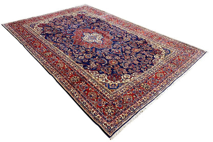 Rug with a diagonal cut: dark blue with a red accent, medallion in the center